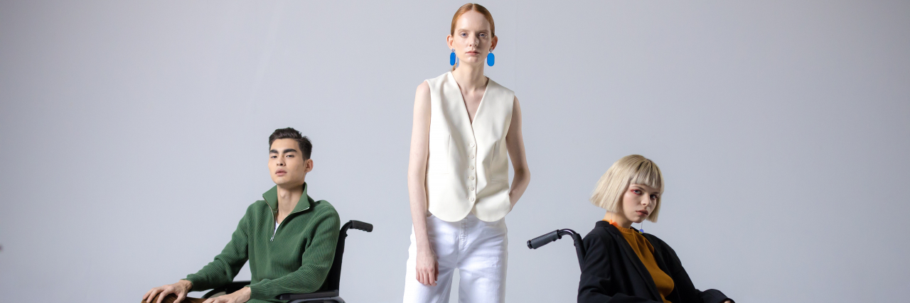 Why Cerebral Palsy Awareness Is Vital This Month (and Every Month) Two wheelchair users and a person with a mobility disability standing between them.