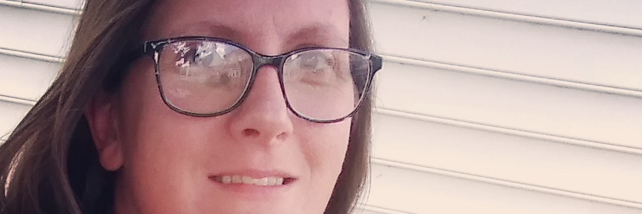 Redefining Self-Care When Parenting a Child With Disabilities Heather outdoors wearing a tank top.