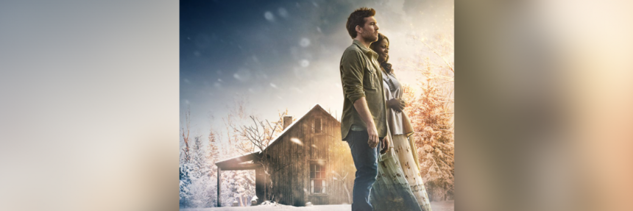 Sam Worthington and Octavia Spencer standing together outside in the snow by a shack, from the movie "The Shack"