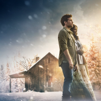 Sam Worthington and Octavia Spencer standing together outside in the snow by a shack, from the movie "The Shack"