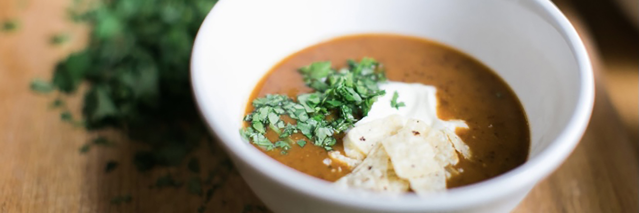 Meeting Dietary Restrictions as a Chef Is Not Just Good Business, It's The Right Thing to Do Bowl of soup on a wooden table.