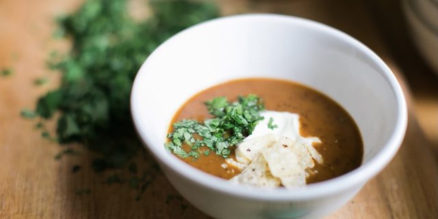 Meeting Dietary Restrictions as a Chef Is Not Just Good Business, It's The Right Thing to Do Bowl of soup on a wooden table.
