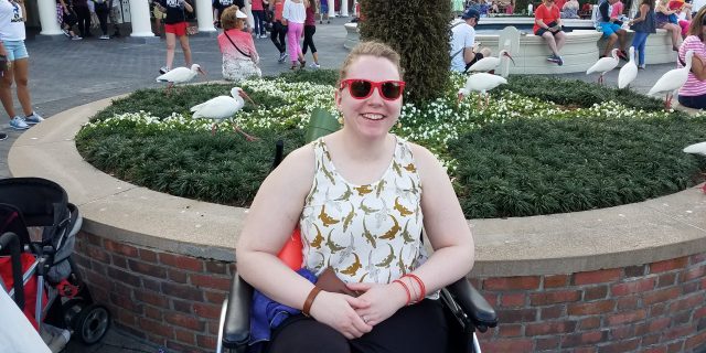 Genny sitting in her wheelchair at Disney World.