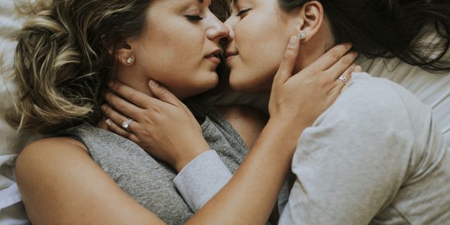 Lesbian couple kissing in the morning.