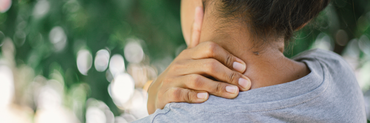 9 Things People Don't Realize You're Doing Because of Migraine Rear View Of Woman With Neckache
