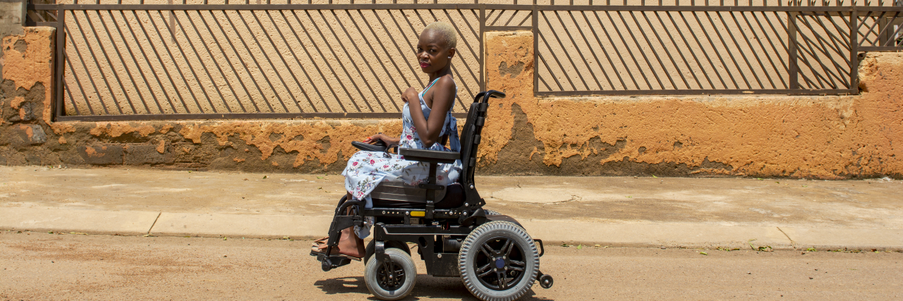 Why You Shouldn't Call Disabled People 'Differently Abled' African woman using power wheelchair.