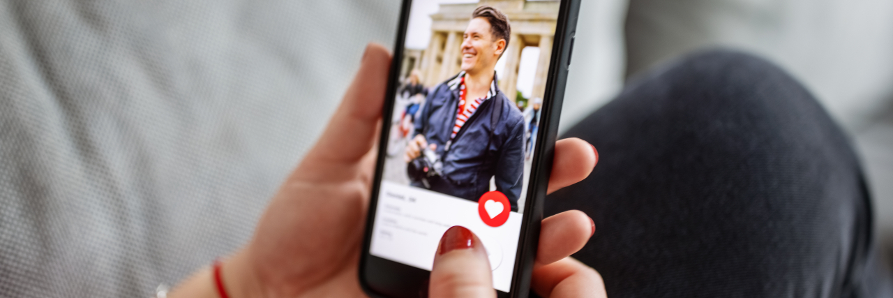 Dating When You Have McCune-Albright Syndrome Woman using a dating app on smart phone.