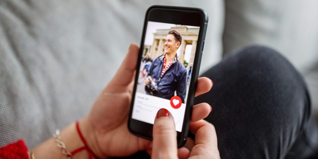 How My Disability Has Shaped My Dating Life Woman using a dating app on smart phone.