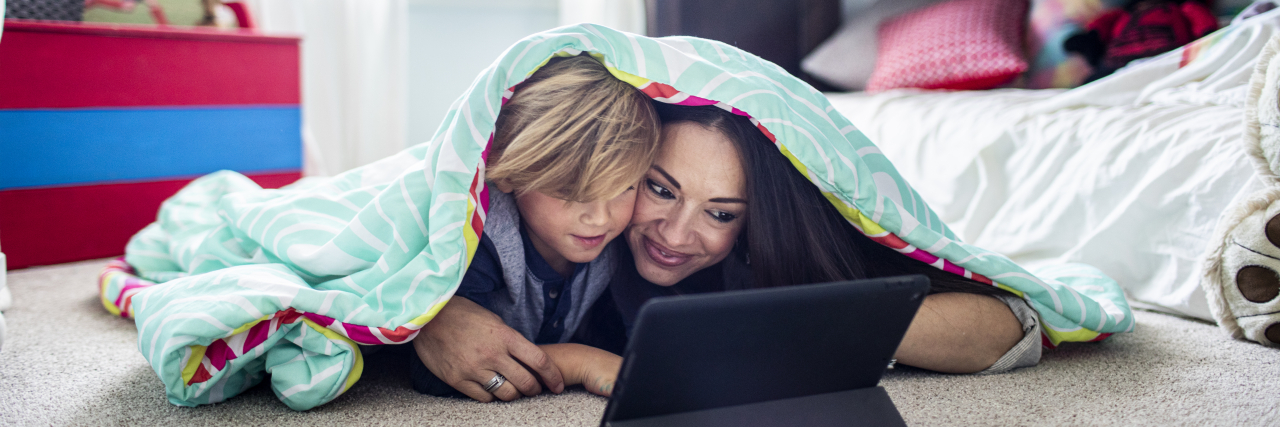 Becoming the Kind of Parent My Child on the Autism Spectrum Needs Mother and son watching tablet together.