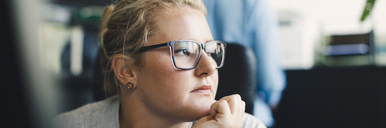 Why Pregnancy Loss Should Be Covered Under Bereavement Leave Sad woman in the office.