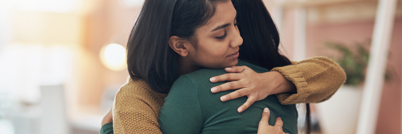 A Letter to the Supportive Friend Who Loves Me With ADHD photo of two people hugging