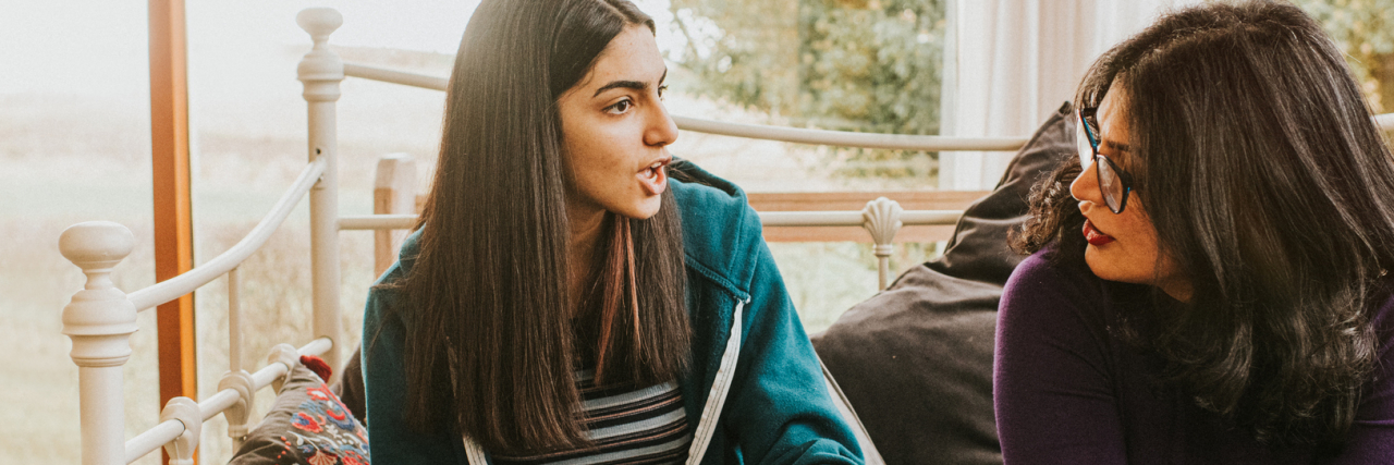 How To Respond To 'Harmless' Comments About ADHD photo of two people talking in a serious conversation
