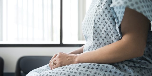 How Sharing Genetic Testing Information Could Have Saved My Wife Midsection of female patient wearing a hospital gown