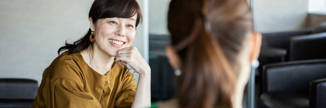 What Therapy Looks Like After You're Doing Better photo of two people talking and smiling
