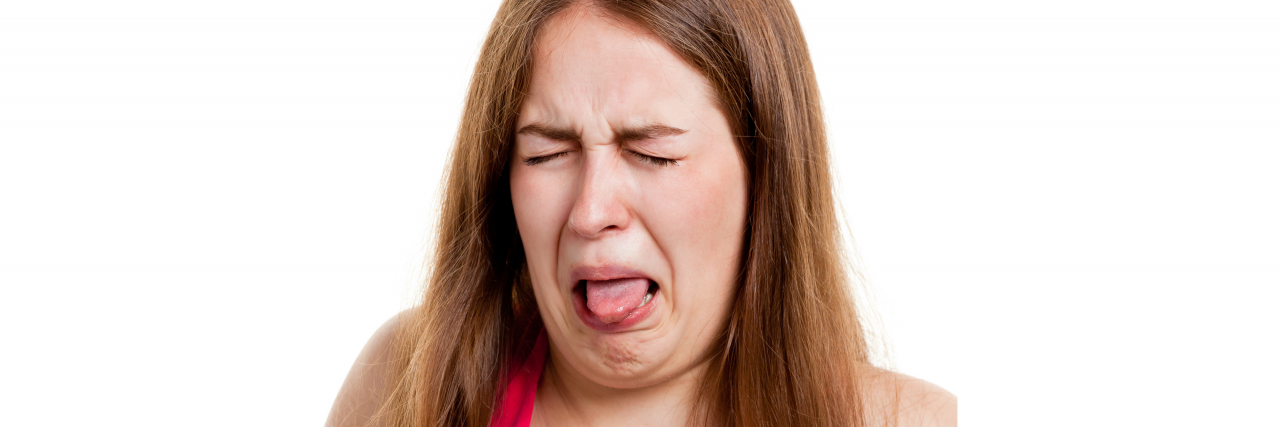 9 Tips for Taking Medicine That Tastes Bad Woman making a disgusted face.