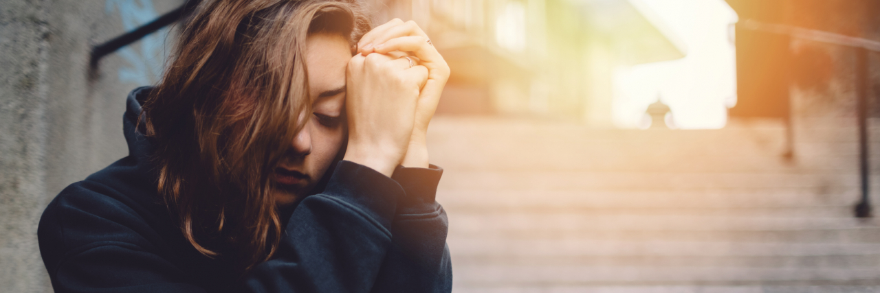 5 Things I Wish My Parents Realized About My Life With Chronic Illness Teen girl sitting on steps looking sad