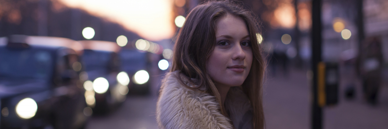 Why You Shouldn't Be Afraid of Seeking Mental Health Help Young woman in street with traffic in background