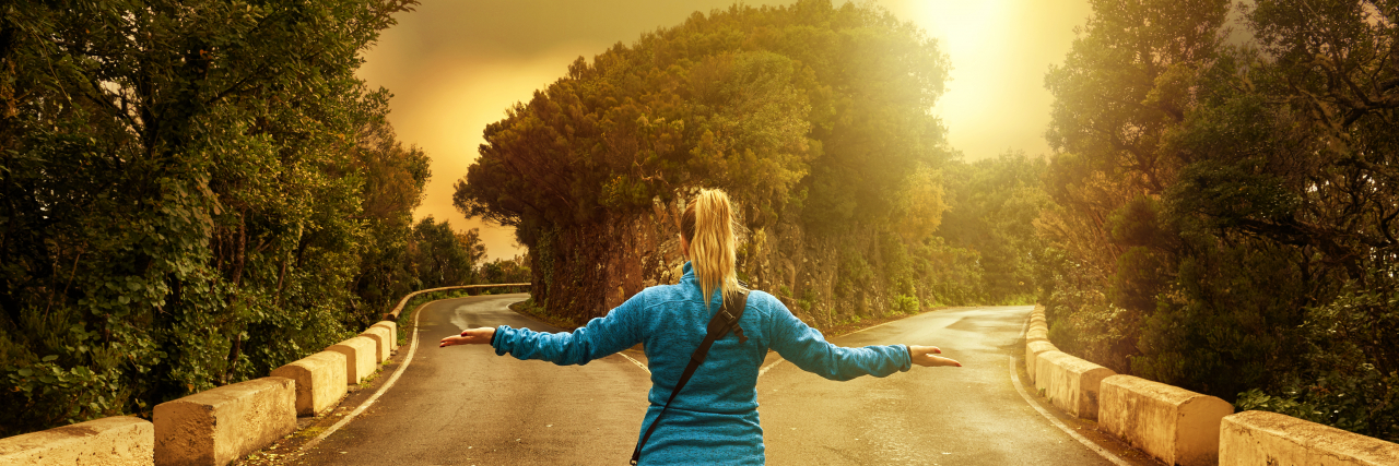 The Pain of Watching Friends Drift Away After Becoming Chronically Ill Woman standing at a fork in the road.