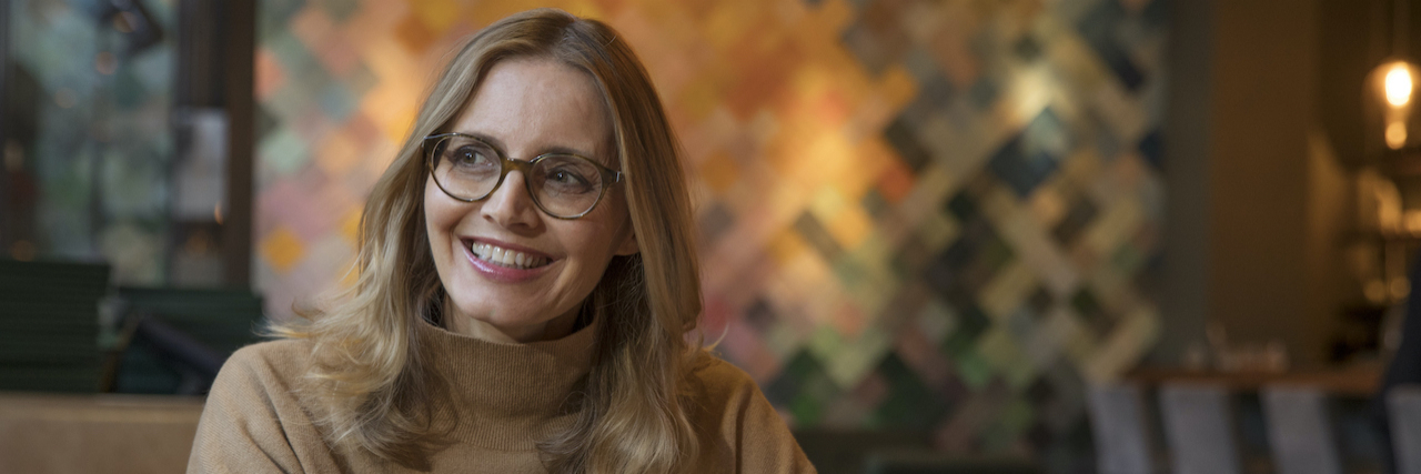 When Food Is the Enemy With Chronic Pancreatitis Portrait of woman wearing glasses and smiling in restaurant