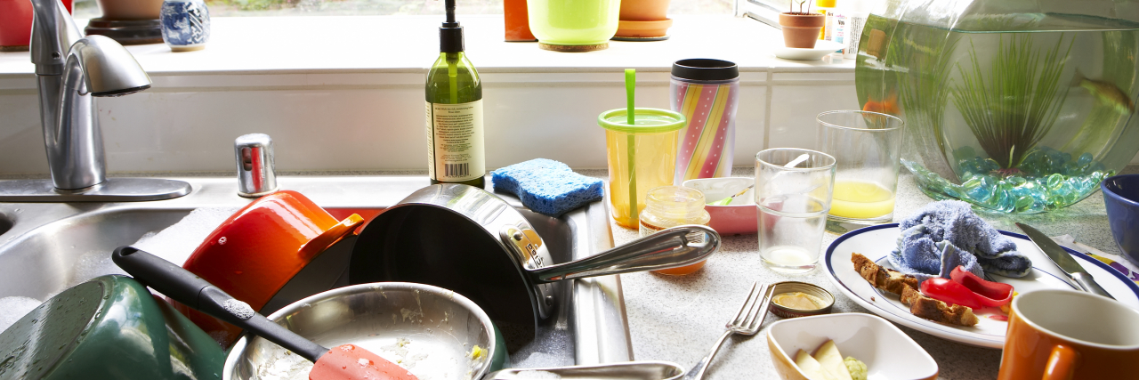 9 Tips for Making a Sensory-Friendly Home Dirty dishes piled in kitchen sink, close-up