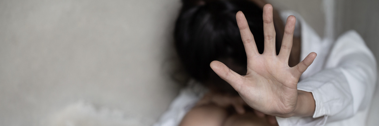 Poem: How Much Trauma Can One Soul Hold? A woman sticking her hand out