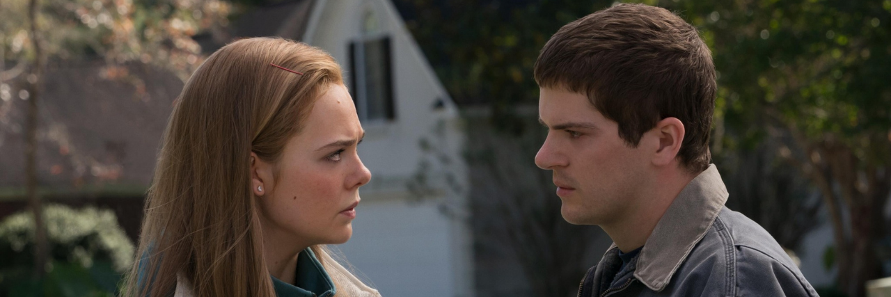 Suicide Method Trigger Warning for 'The Girl From Plainville' Michelle Carter and Conrad Roy III characters portrayed in The Girl From Plainville, both standing outside looking at each other intensely