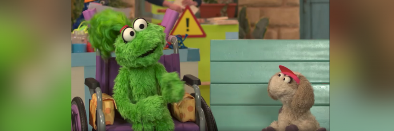 New Sesame Workshop Muppet With Disability Uses a Wheelchair Muppet Ameera in her wheelchair speaking with another muppet