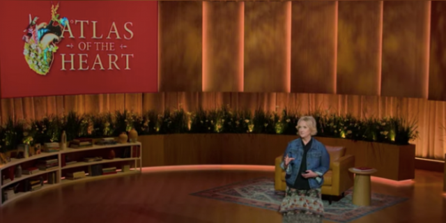 Brené Brown's New Docuseries Is the Emotional Education We All Need Brene Brown on stage with "Atlas of the Heart" text and image on screen behind her
