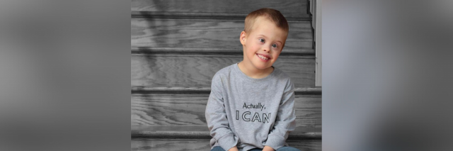 Cody, a smiling boy who has Down syndrome.