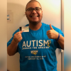 Kris wearing an Autism: Embrace the Amazing shirt.