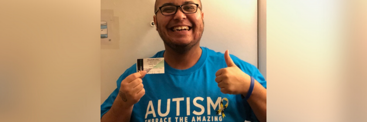 Kris wearing an Autism: Embrace the Amazing shirt.