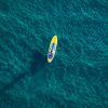 Aerial view of a person in a kayak in the ocean.