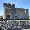 photo of a small stonework castle and wall in Ireland