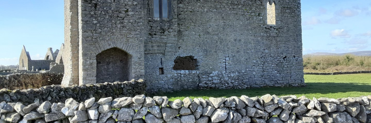 photo of a small stonework castle and wall in Ireland
