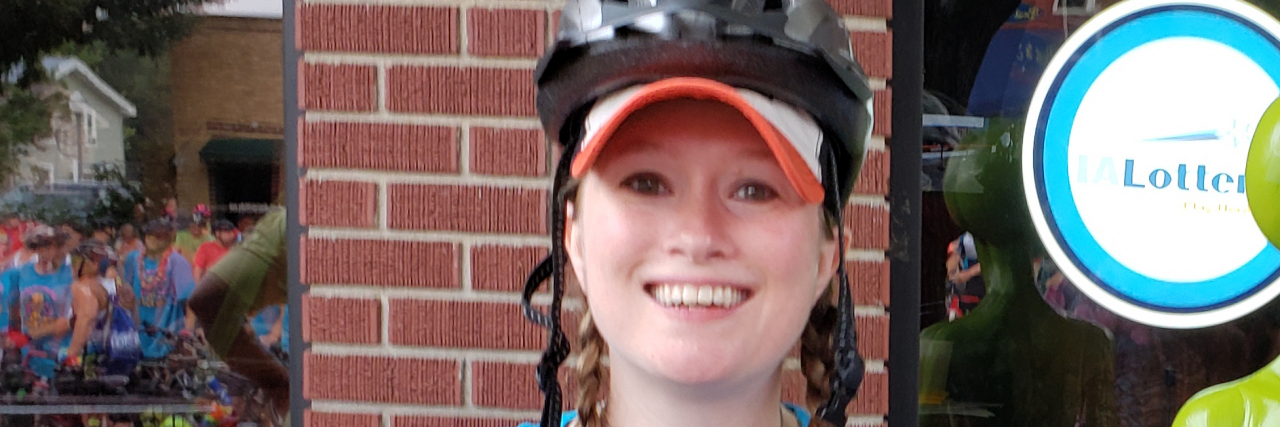 The 5 Stages of Fibromyalgia Diagnosis and What Happens Next Christina Irene outdoors wearing a baseball cap and blue t-shirt.