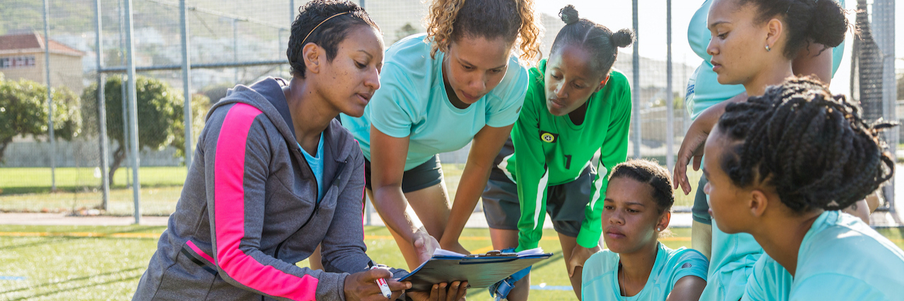 The Coach Who Supported Me Through Eating Disorder Struggles Diverse group of girls soccer team listening to their female coach