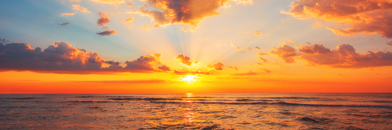 How I’ve Struggled With Spirituality After a Medical Trauma That Led to Disability Beautiful sunset over the tropical sea.