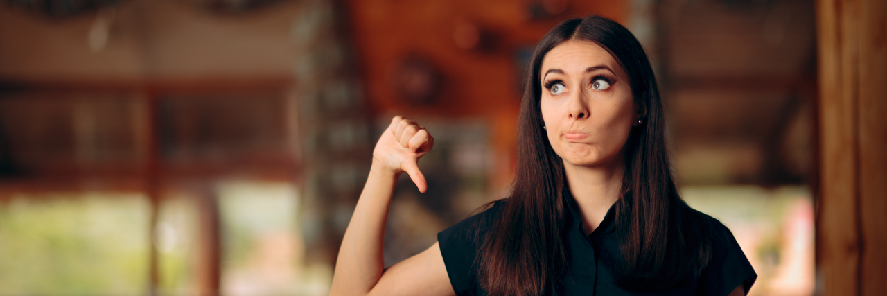 Endometriosis: A Humorous 'Restaurant Review' Woman giving thumbs down in a restaurant.