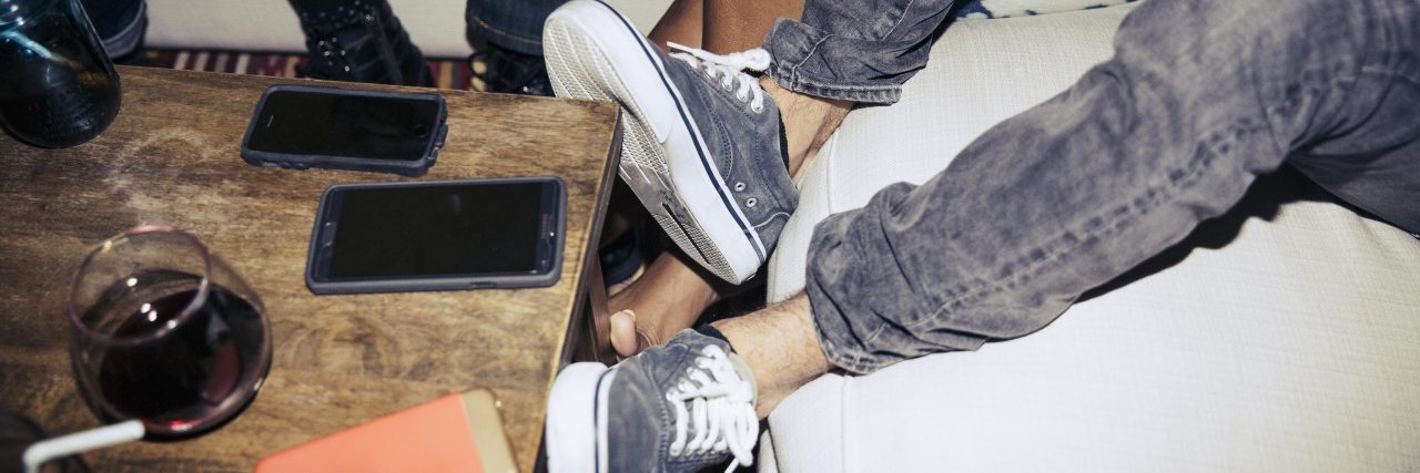 Why Pop Culture Matters in Health and Disability Advocacy Low section of friends sitting on sofa by coffee table in living room