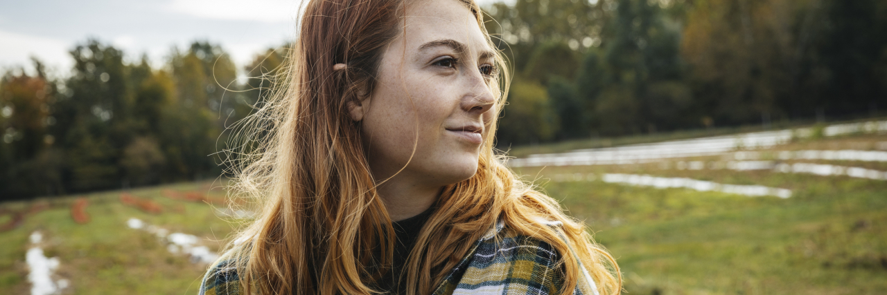 Read This If You're Struggling to Accept Your Schizophrenia Diagnosis photo of a young woman wrapped in a blanket looking confident