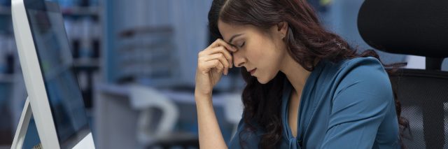 photo of a woman looking stressed or tired in an office