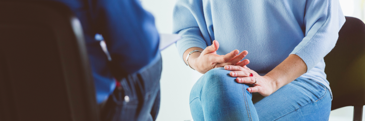 Questions to Ask a New Therapist for Borderline Personality Disorder photo of a person talking with a therapist, close up on their chairs and bodies