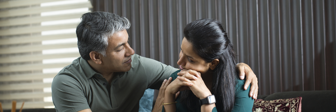 5 Ways My Marriage Is Better Because of Chronic Illness Woman consoled by her husband at home.