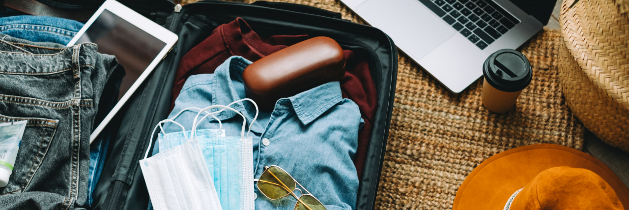 Questions to Ask About Accessibility When Choosing Where to Travel Packing suitcase for travel vacation.