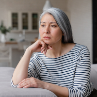 Tired, thoughtful woman with gray hair.