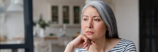Tired, thoughtful woman with gray hair.