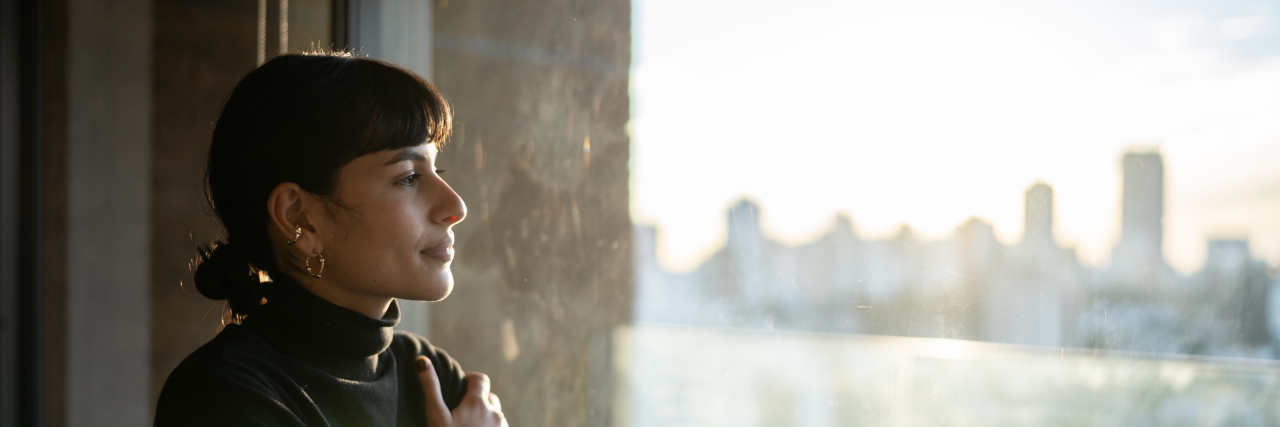 Woman contemplating at home.