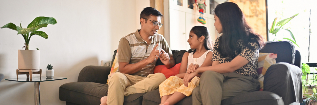 The Pandemic Has Raised Mental Health Conversation in Parents and Kids Parents sitting on a sofa and having a serious discussion with their daughter
