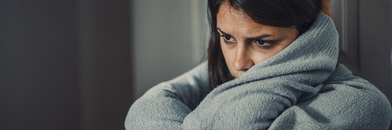 Borderline Personality Disorder Glossary for the Newly Diagnosed photo of a young woman looking upset, staring off into space