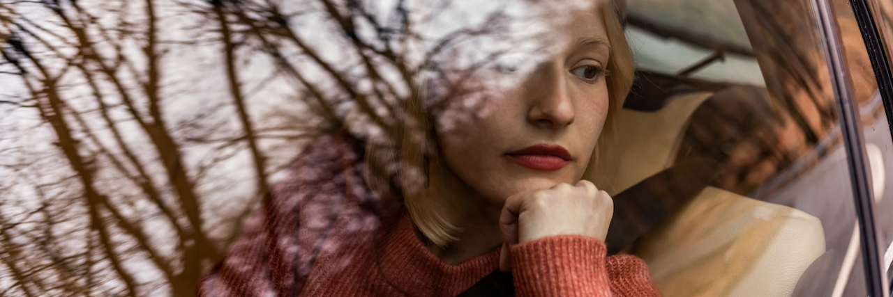 When Chronic Illness Makes You Feel Numb to Your Own Life A woman looking out a car window